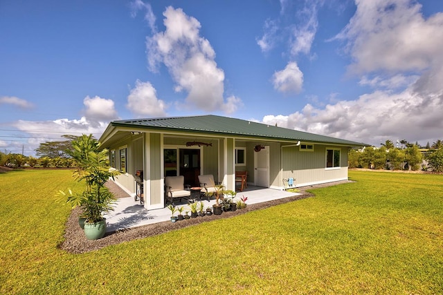 16-1516 Pohaku Cir, Keaau, HI 96749 - back of house featuring a patio area, a lawn, and metal roof