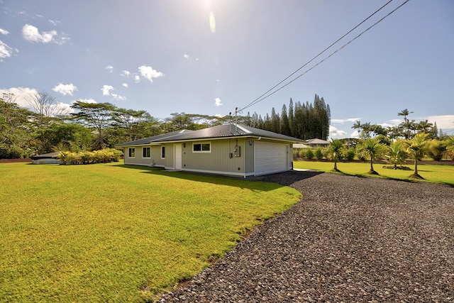 16-1516 Pohaku Cir, Keaau, HI 96749 - view of side of home featuring a lawn and a detached garage