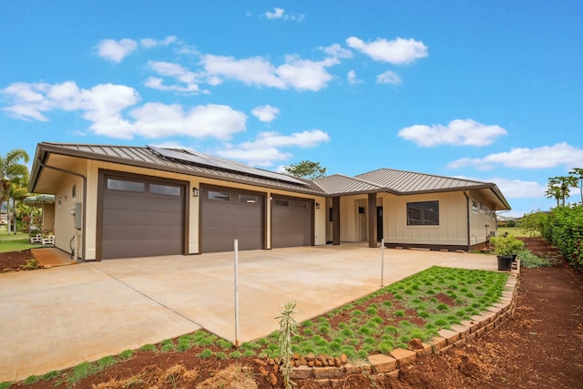 4306 Pilimai St, Lihue, HI 96766 - view of front of house featuring a standing seam roof, driveway, board and batten siding, a garage, and a metal roof