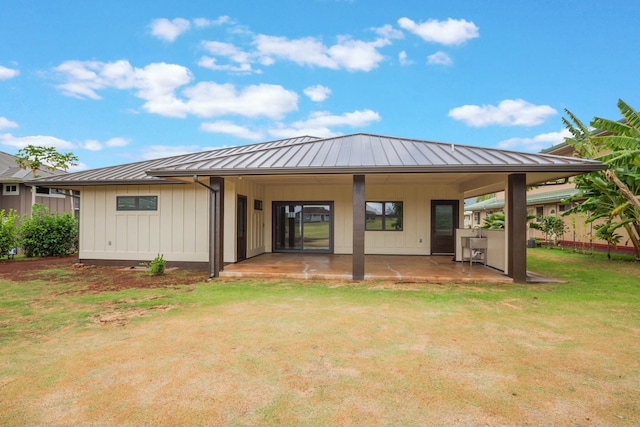 4306 Pilimai St, Lihue, HI 96766 - rear view of house with a standing seam roof, a patio area, a metal roof, and a yard