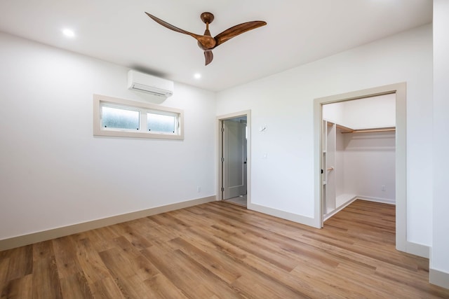 4306 Pilimai St, Lihue, HI 96766 - unfurnished bedroom featuring an AC wall unit, light wood-style flooring, a spacious closet, a ceiling fan, and recessed lighting