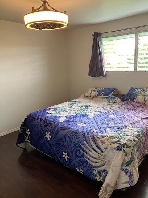 470 Hoopuni St, Hilo, HI 96720 - bedroom with baseboards and wood finished floors
