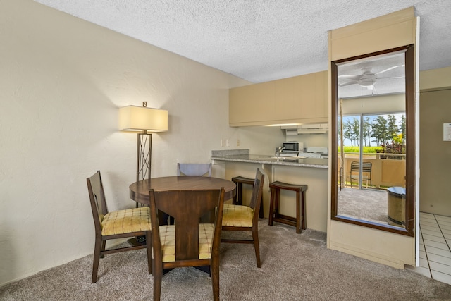 525 Aleka Lp Unit F6, Kapaa, HI 96746 - dining area with carpet floors, ceiling fan, and a textured ceiling