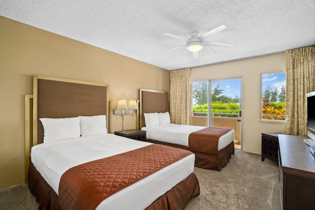 525 Aleka Lp Unit F6, Kapaa, HI 96746 - carpeted bedroom featuring a textured ceiling, ceiling fan, and access to exterior