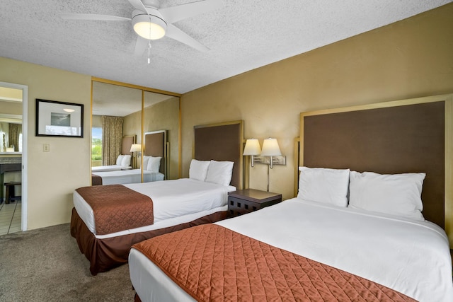 525 Aleka Lp Unit F6, Kapaa, HI 96746 - bedroom featuring a closet, a textured ceiling, ceiling fan, and carpet flooring