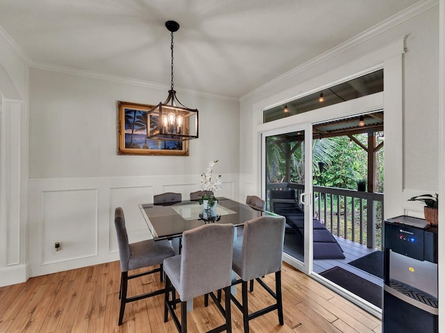 16-2069 Leilani Dr, Pahoa, HI 96778 - dining space with light wood finished floors, ornamental molding, a chandelier, a decorative wall, and a wainscoted wall