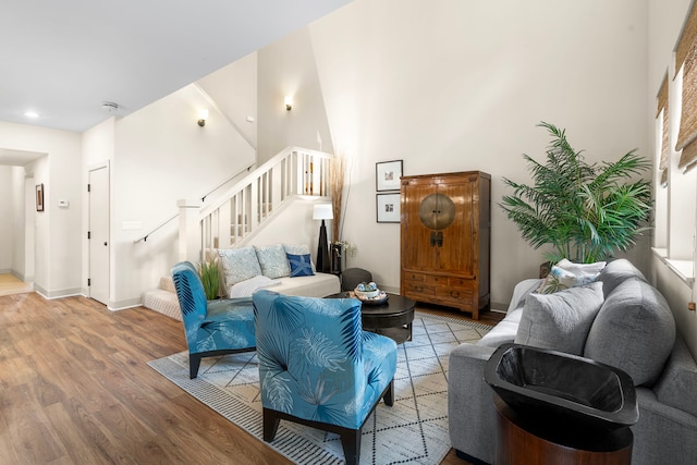 69-1033 Nawahine Pl Unit 1G, Waikoloa, HI 96738 - living area with light wood-style floors, stairway, baseboards, recessed lighting, and a high ceiling