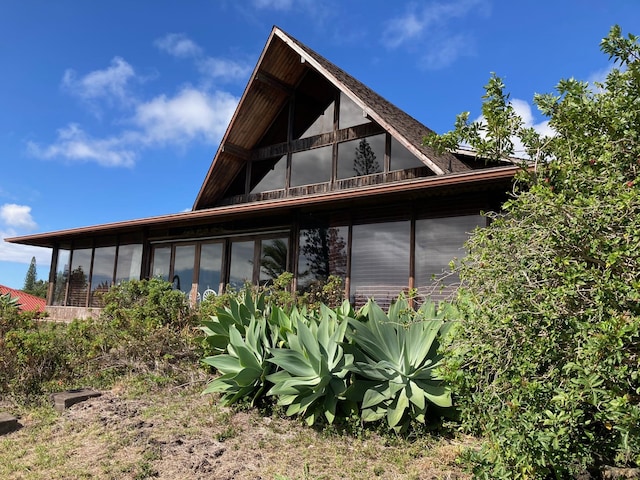 94-1790 Kaulua St, Naalehu, HI 96772 - view of property exterior with a sunroom