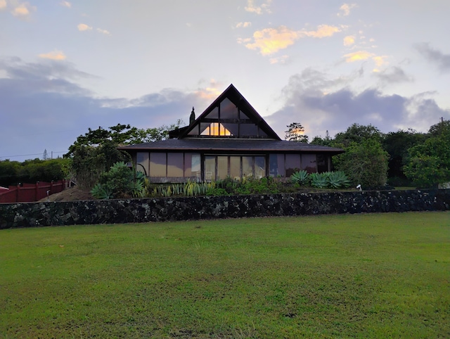 94-1790 Kaulua St, Naalehu, HI 96772 - rear view of house featuring a yard and a sunroom