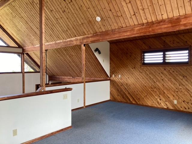 94-1790 Kaulua St, Naalehu, HI 96772 - additional living space featuring wooden walls, carpet floors, and a wood ceiling with exposed beams