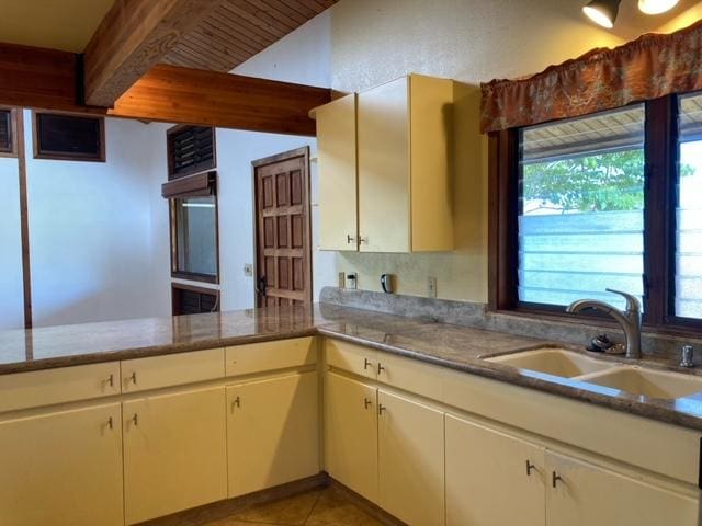 94-1790 Kaulua St, Naalehu, HI 96772 - kitchen with beam ceiling and light tile patterned floors