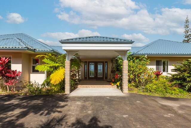 73-4571 Kukuki St Unit A, Kailua-Kona, HI 96740 - entrance to property featuring french doors, stucco siding, and a tiled roof