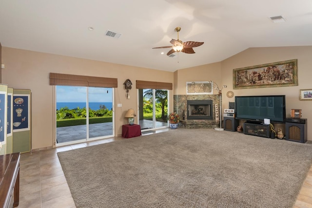 73-4571 Kukuki St Unit A, Kailua-Kona, HI 96740 - living area featuring a ceiling fan, a stone fireplace, vaulted ceiling, and light tile patterned floors