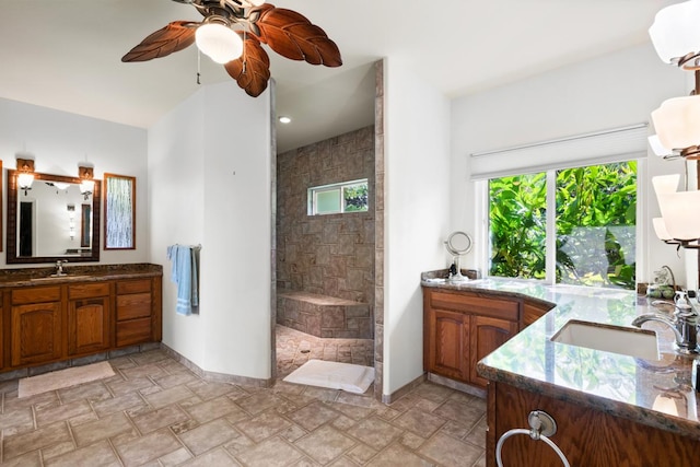 73-4571 Kukuki St Unit A, Kailua-Kona, HI 96740 - full bathroom with two vanities, a ceiling fan, walk in shower, stone finish floors, and baseboards