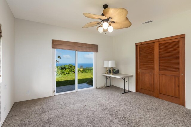 73-4571 Kukuki St Unit A, Kailua-Kona, HI 96740 - bedroom with access to exterior, carpet floors, ceiling fan, and a closet