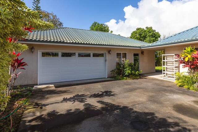 73-4571 Kukuki St Unit A, Kailua-Kona, HI 96740 - view of front of property with concrete driveway, stucco siding, a garage, and a tiled roof