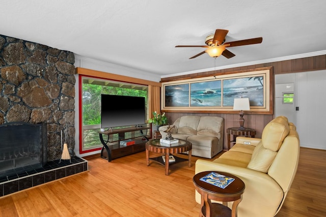 3875 Gallo Pl, Kalaheo, HI 96741 - living room featuring a ceiling fan, wood finished floors, ornamental molding, and a tile fireplace