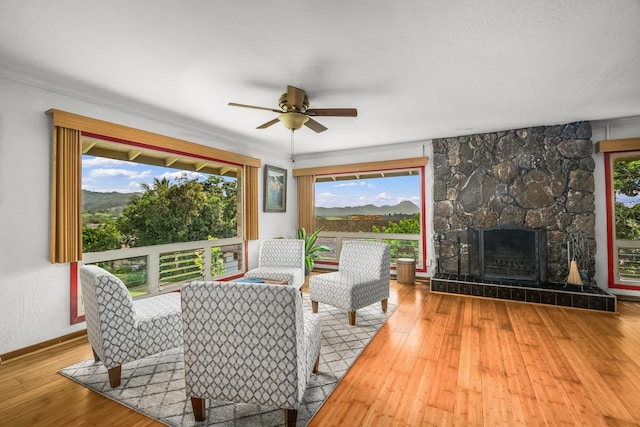 3875 Gallo Pl, Kalaheo, HI 96741 - living room with ceiling fan, hardwood / wood-style floors, healthy amount of natural light, and a large fireplace