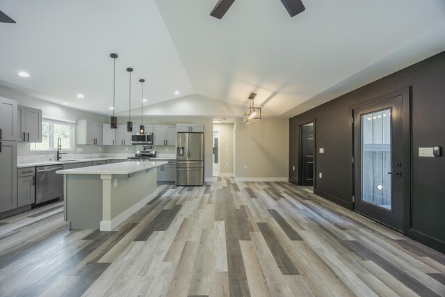 15-1674 24th Ave, Keaau, HI 96749 - kitchen with appliances with stainless steel finishes, a sink, light countertops, vaulted ceiling, and a center island