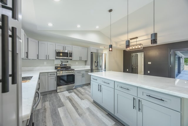 15-1674 24th Ave, Keaau, HI 96749 - kitchen featuring stainless steel appliances, light wood-type flooring, lofted ceiling, gray cabinetry, and light stone counters