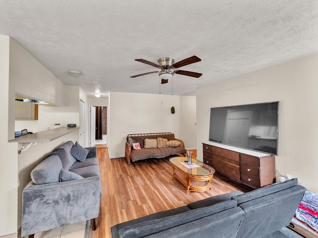 74-5156 Kialoa Pl, Kailua-Kona, HI 96740 - living area with light wood-style floors, ceiling fan, a textured ceiling, and baseboards