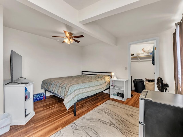 74-5156 Kialoa Pl, Kailua-Kona, HI 96740 - bedroom with wood finished floors, beamed ceiling, ceiling fan, freestanding refrigerator, and a walk in closet