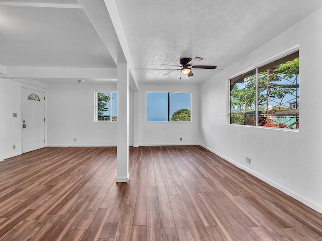 74-5156 Kialoa Pl, Kailua-Kona, HI 96740 - unfurnished living room with a ceiling fan, a textured ceiling, baseboards, and wood finished floors