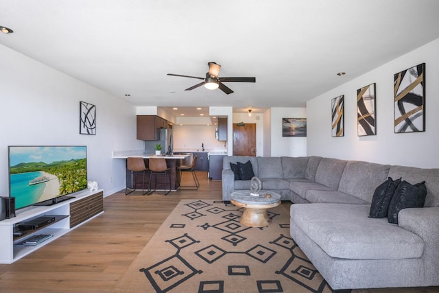 78-7070 Alii Dr Unit B202, Kailua-Kona, HI 96740 - living area featuring light wood finished floors, ceiling fan, and baseboards