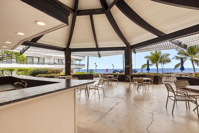 75-6082 Alii Dr # B333, Kailua-Kona, HI 96740 - view of patio / terrace with a gazebo, a water view, and outdoor dining space
