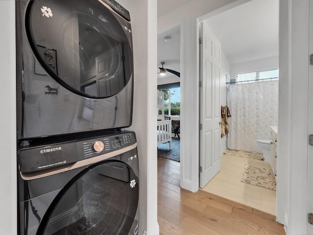 75-6009 Alii Dr Unit H2, Kailua-Kona, HI 96740 - laundry area featuring stacked washer and clothes dryer, wood-type flooring, and ceiling fan