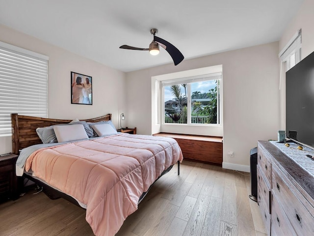 75-6009 Alii Dr Unit H2, Kailua-Kona, HI 96740 - bedroom with light wood-style flooring, baseboards, and a ceiling fan