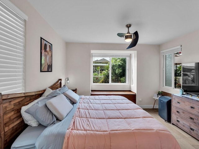 75-6009 Alii Dr Unit H2, Kailua-Kona, HI 96740 - bedroom featuring multiple windows, light wood-type flooring, baseboards, and ceiling fan