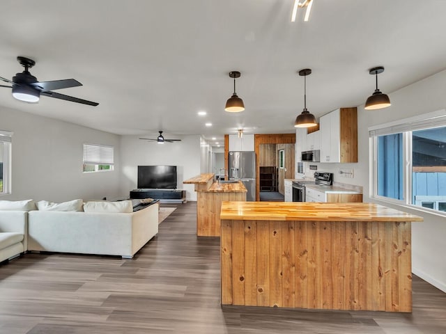 74-5071 Kealapua St, Kailua-Kona, HI 96740 - kitchen featuring appliances with stainless steel finishes, open floor plan, ceiling fan, butcher block counters, and a center island