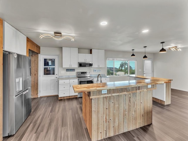 74-5071 Kealapua St, Kailua-Kona, HI 96740 - kitchen featuring appliances with stainless steel finishes, wood counters, dark wood-type flooring, recessed lighting, and white cabinetry
