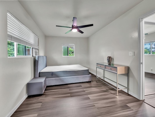 74-5071 Kealapua St, Kailua-Kona, HI 96740 - bedroom featuring multiple windows, baseboards, wood finished floors, and ceiling fan