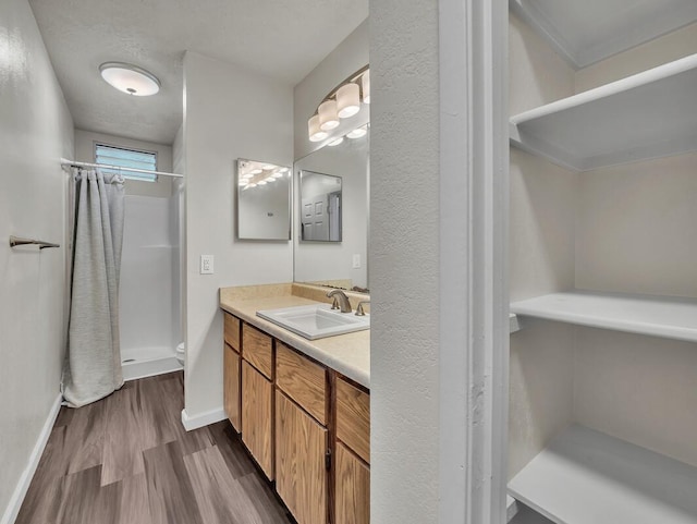 74-5071 Kealapua St, Kailua-Kona, HI 96740 - bathroom featuring vanity, a stall shower, wood finished floors, and baseboards