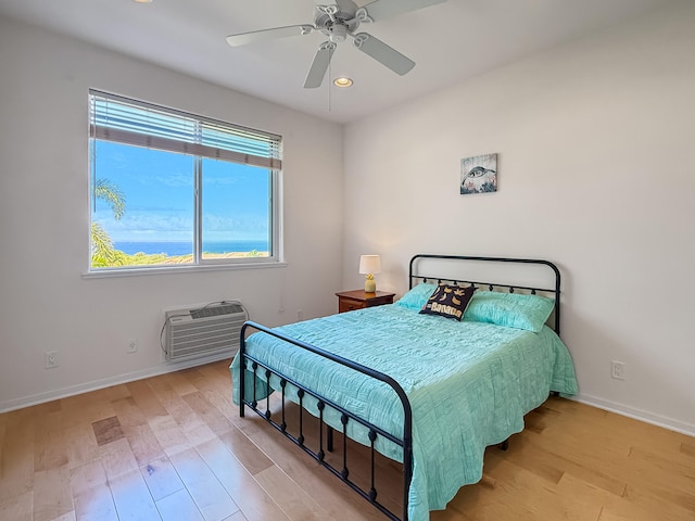 75-346 Hualalai Rd Unit B202, Kailua-Kona, HI 96740 - bedroom with light wood finished floors, recessed lighting, a ceiling fan, and an AC wall unit