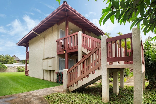 4461 Kamoa Rd Unit B22, Kapaa, HI 96746 - view of home's exterior with a wooden deck, stairs, and stucco siding