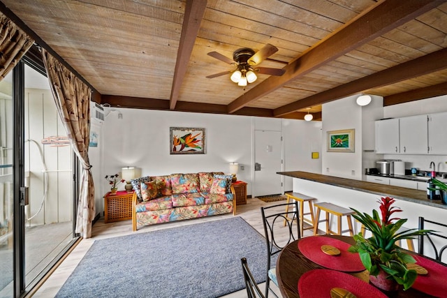 76-6246 Alii Dr Unit 343, Kailua-Kona, HI 96740 - living area featuring wood ceiling with exposed beams, light wood finished floors, and ceiling fan