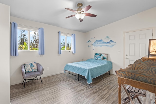 11-3458 Lehua St, Mountain View, HI 96771 - bedroom featuring light wood-type flooring, multiple windows, baseboards, and ceiling fan