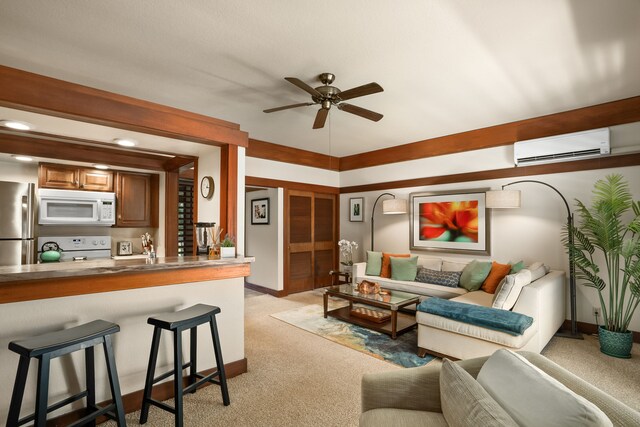 2253 Poipu Rd Unit 426, Koloa, HI 96756 - living area featuring a wall mounted AC, light carpet, ceiling fan, and baseboards