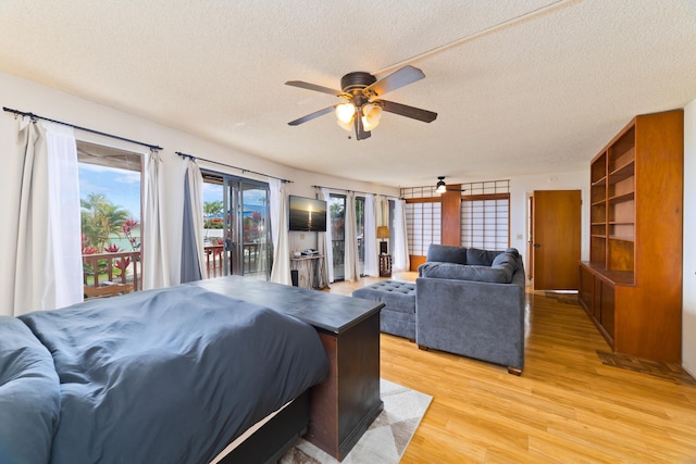 73-4327 Oneone St, Kailua-Kona, HI 96740 - bedroom with a textured ceiling, access to outside, light wood-style flooring, and a ceiling fan