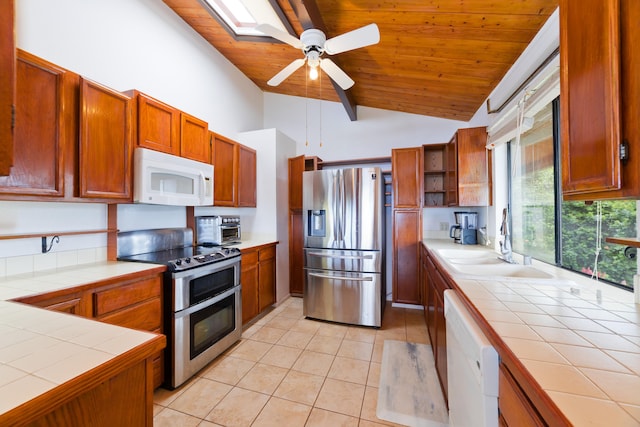73-4327 Oneone St, Kailua-Kona, HI 96740 - kitchen featuring appliances with stainless steel finishes, tile counters, wood ceiling, light tile patterned floors, and ceiling fan