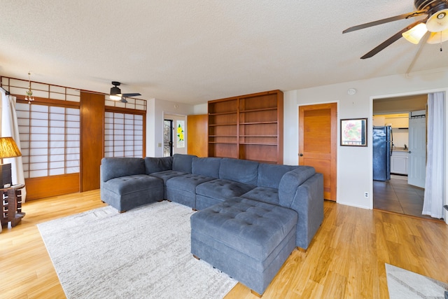 73-4327 Oneone St, Kailua-Kona, HI 96740 - living area with a ceiling fan, a textured ceiling, and light wood-style floors