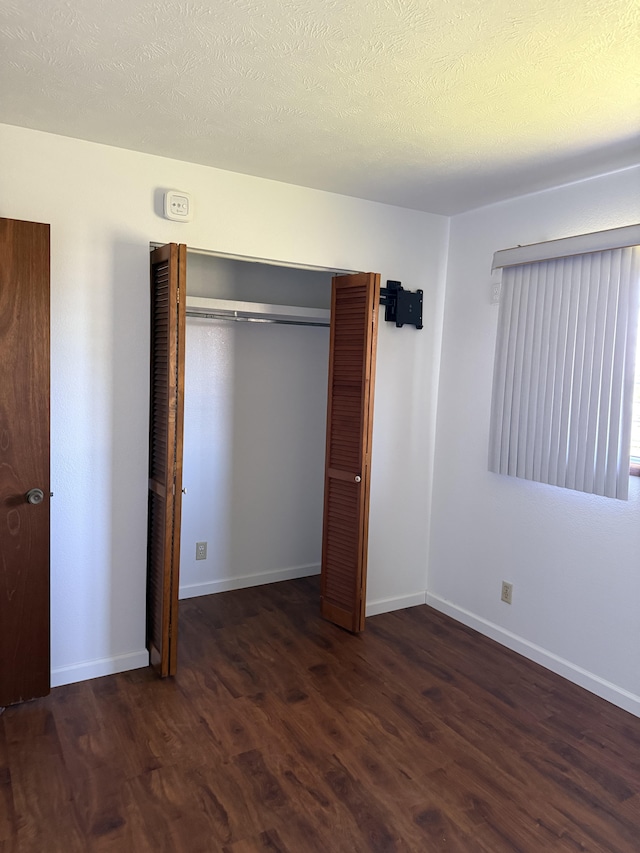 1572 Kaupili Pl, Hilo, HI 96720 - unfurnished bedroom featuring wood finished floors, a closet, and baseboards