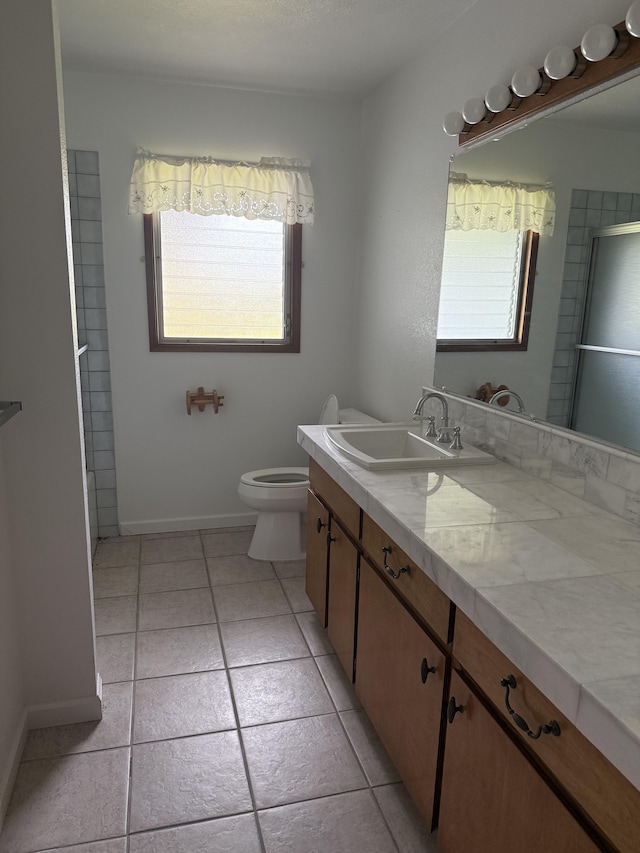 1572 Kaupili Pl, Hilo, HI 96720 - bathroom with vanity, toilet, tile patterned flooring, and baseboards