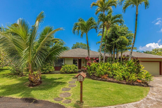 4030 Pauahi Pl, Princeville, HI 96722 - view of front facade featuring a garage, a front lawn, concrete driveway, and a shingled roof