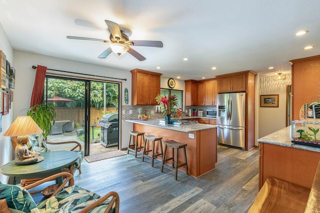 4030 Pauahi Pl, Princeville, HI 96722 - kitchen featuring stainless steel appliances, a peninsula, backsplash, dark wood-type flooring, and recessed lighting
