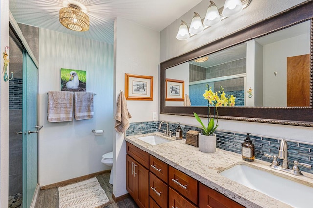 4030 Pauahi Pl, Princeville, HI 96722 - full bath featuring a stall shower, double vanity, toilet, tasteful backsplash, and wood finished floors