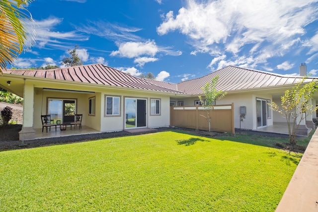 73-4558 Kukuki St, Kailua-Kona, HI 96740 - rear view of property with a standing seam roof, a metal roof, stucco siding, and a lawn